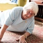 Elderly woman on the floor, reaching for help. Senior woman in distress, needs assistance. Elderly care, safety for senior woman. Emergency for elderly woman. Senior woman on the floor need help.