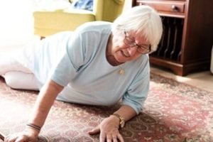 Elderly woman on the floor, reaching for help. Senior woman in distress, needs assistance. Elderly care, safety for senior woman. Emergency for elderly woman. Senior woman on the floor need help.