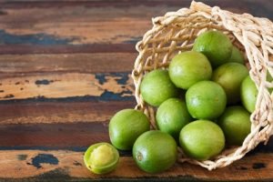 Brazilian fruit Spondias tuberosa (Brazil plum, umbu, imbu) in wicker basket. Selective focus. Copy space