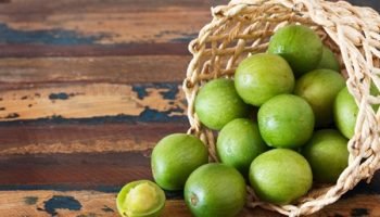 Brazilian fruit Spondias tuberosa (Brazil plum, umbu, imbu) in wicker basket. Selective focus. Copy space