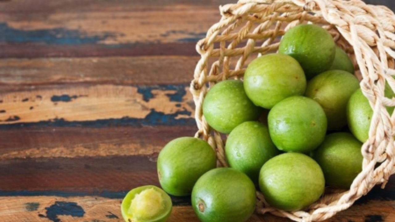 Brazilian fruit Spondias tuberosa (Brazil plum, umbu, imbu) in wicker basket. Selective focus. Copy space