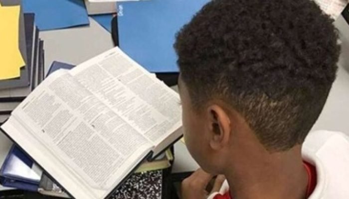 aluno-lendo-biblia-em-escola
