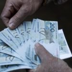 cedulas-de-200-reais-na-mao-de-homem-848x477-1